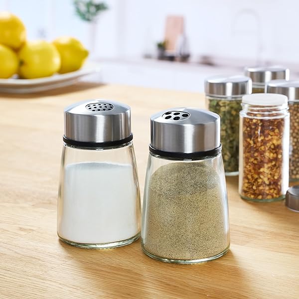 KAMENSTEIN SALT AND PEPPER FILLED GLASS SHAKERS WITH ROTATING SHIFTERS. FEATURES SWIVEL TOP WITH 4 SETTINGS- LIGHT SEASONING, HEAVY SEASONING, POUR, CLOSE, SET OF 2