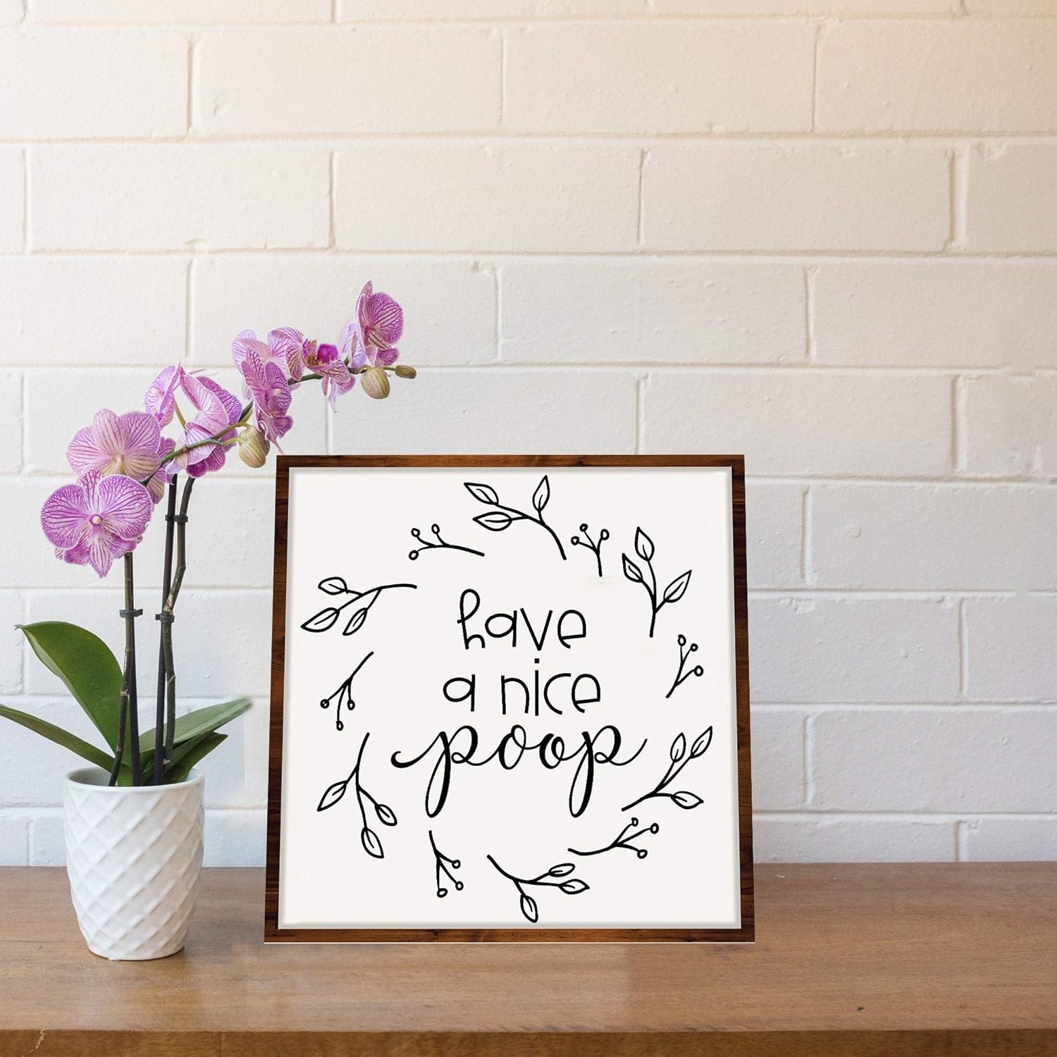 Señal de regalo con texto en inglés "Have a nice poop", enmarcado en