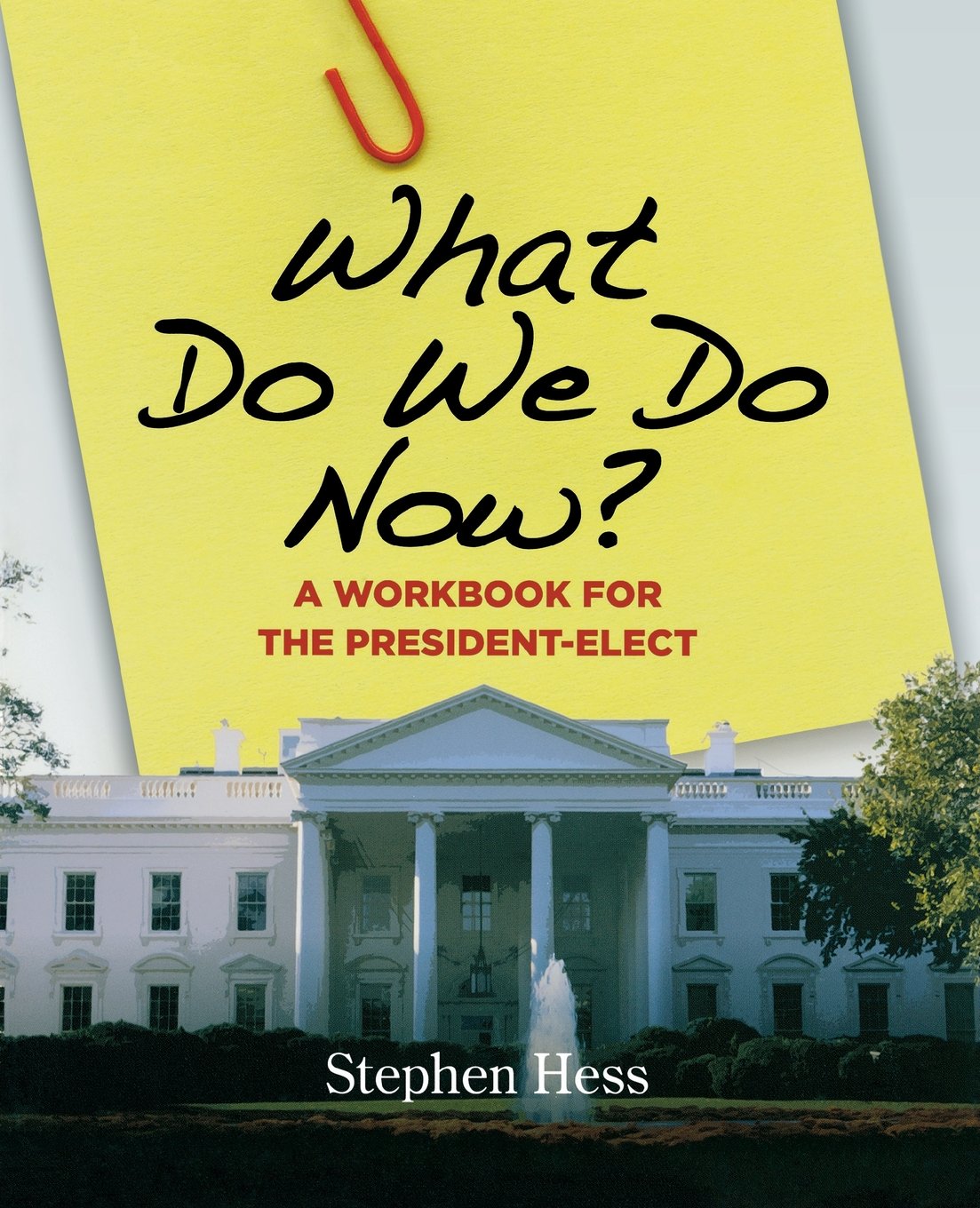 The cover of What Do We Do Now?: A Workbook for the President-Elect. There is a sticky note with the title pictured above the white house. 
