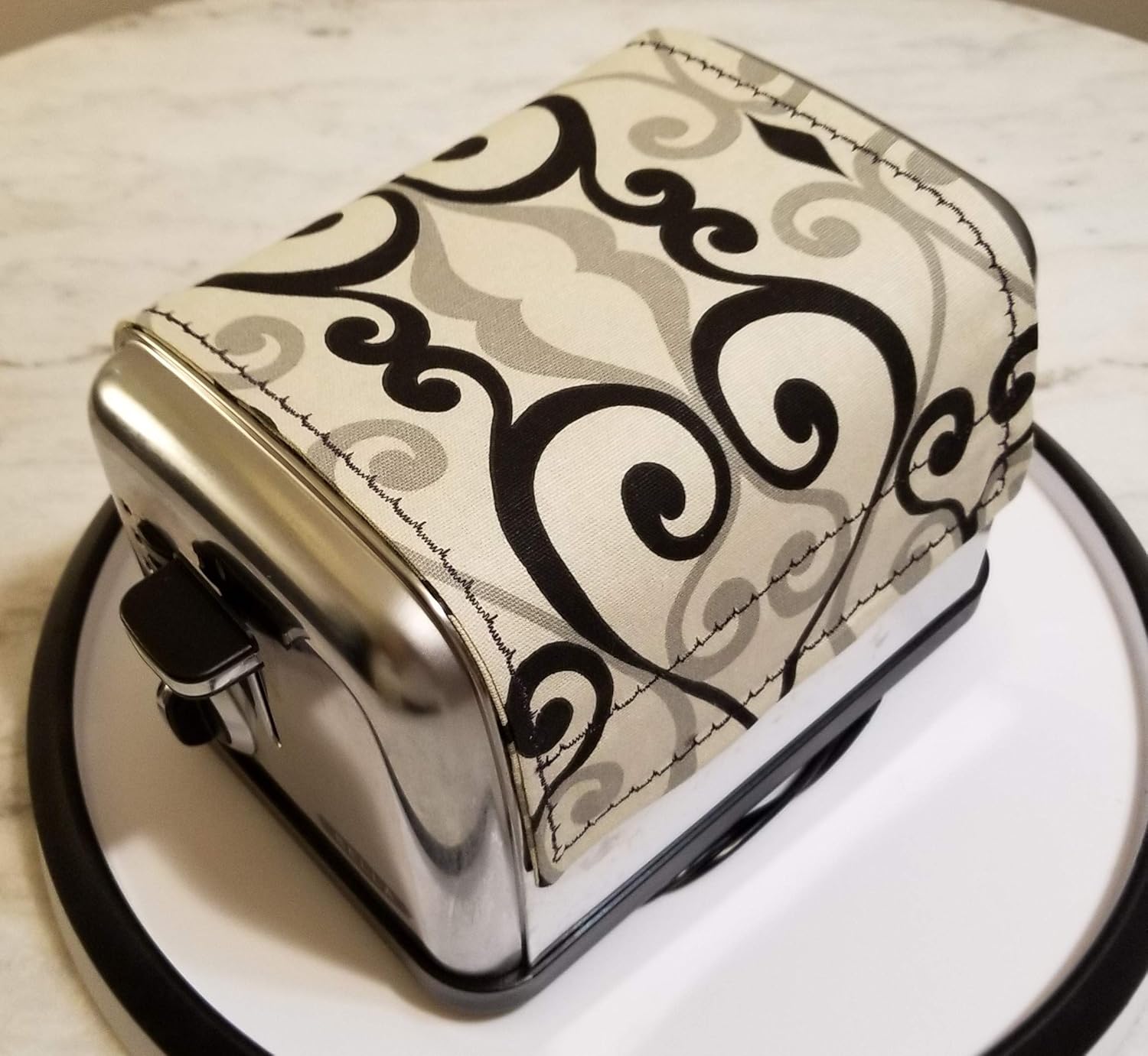 Toaster Cover by Toaster Huggee® will protect your open toaster slots by keeping