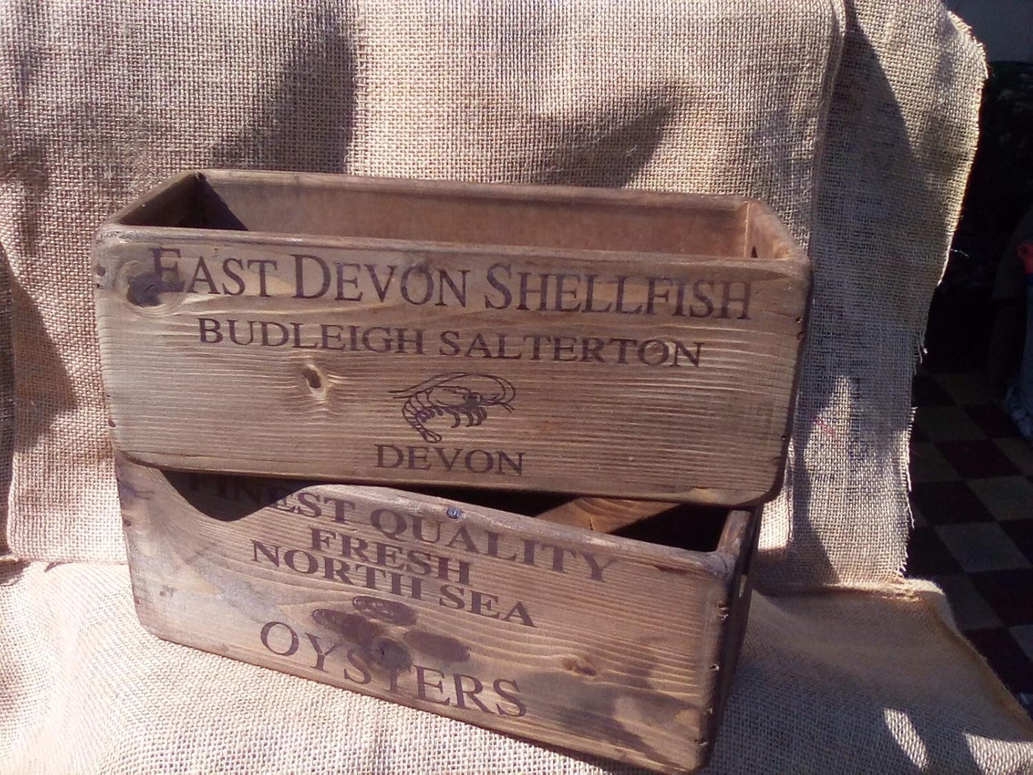 Rustic wooden seafood themed storage boxes. North Sea Oysters or East
