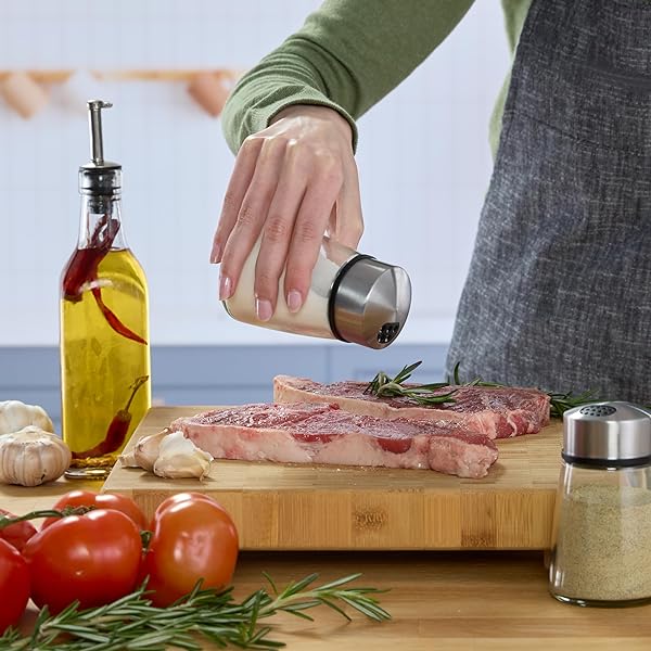 KAMENSTEIN SALT AND PEPPER FILLED GLASS SHAKERS WITH ROTATING SHIFTERS. FEATURES SWIVEL TOP WITH 4 SETTINGS- LIGHT SEASONING, HEAVY SEASONING, POUR, CLOSE, SET OF 2