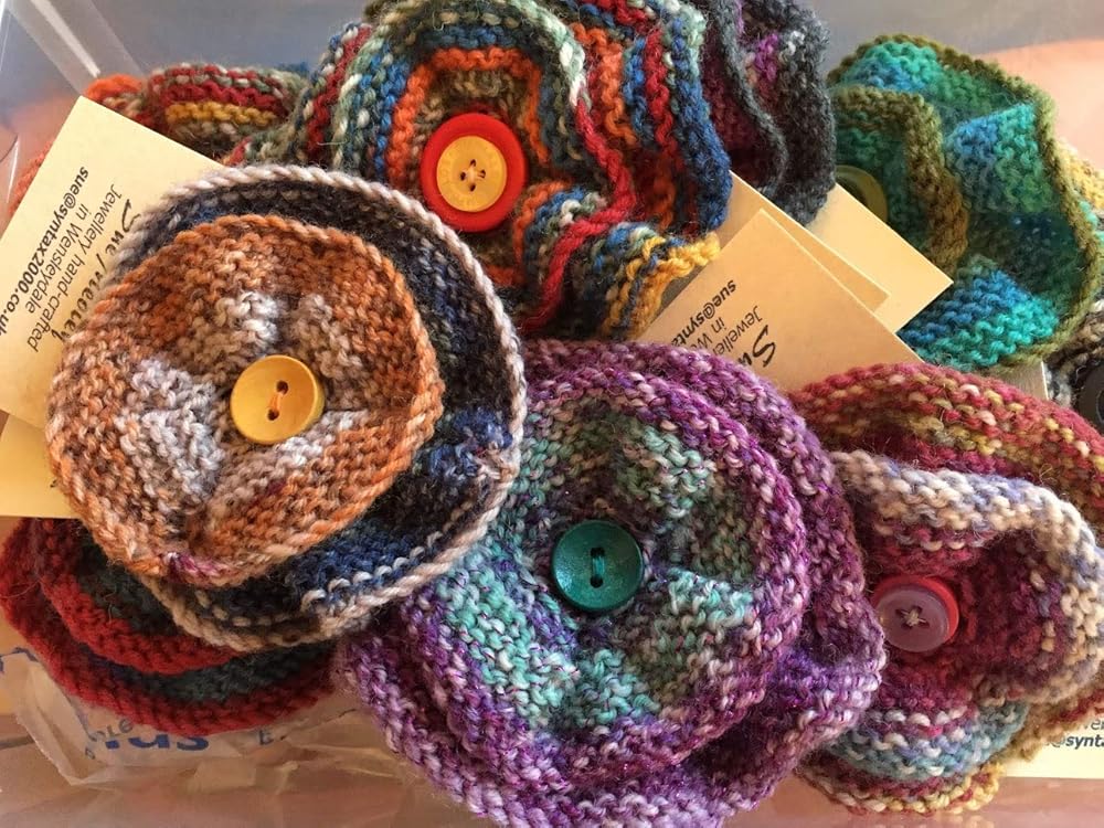 Handknitted round flower brooches, various colours, assorted sizes