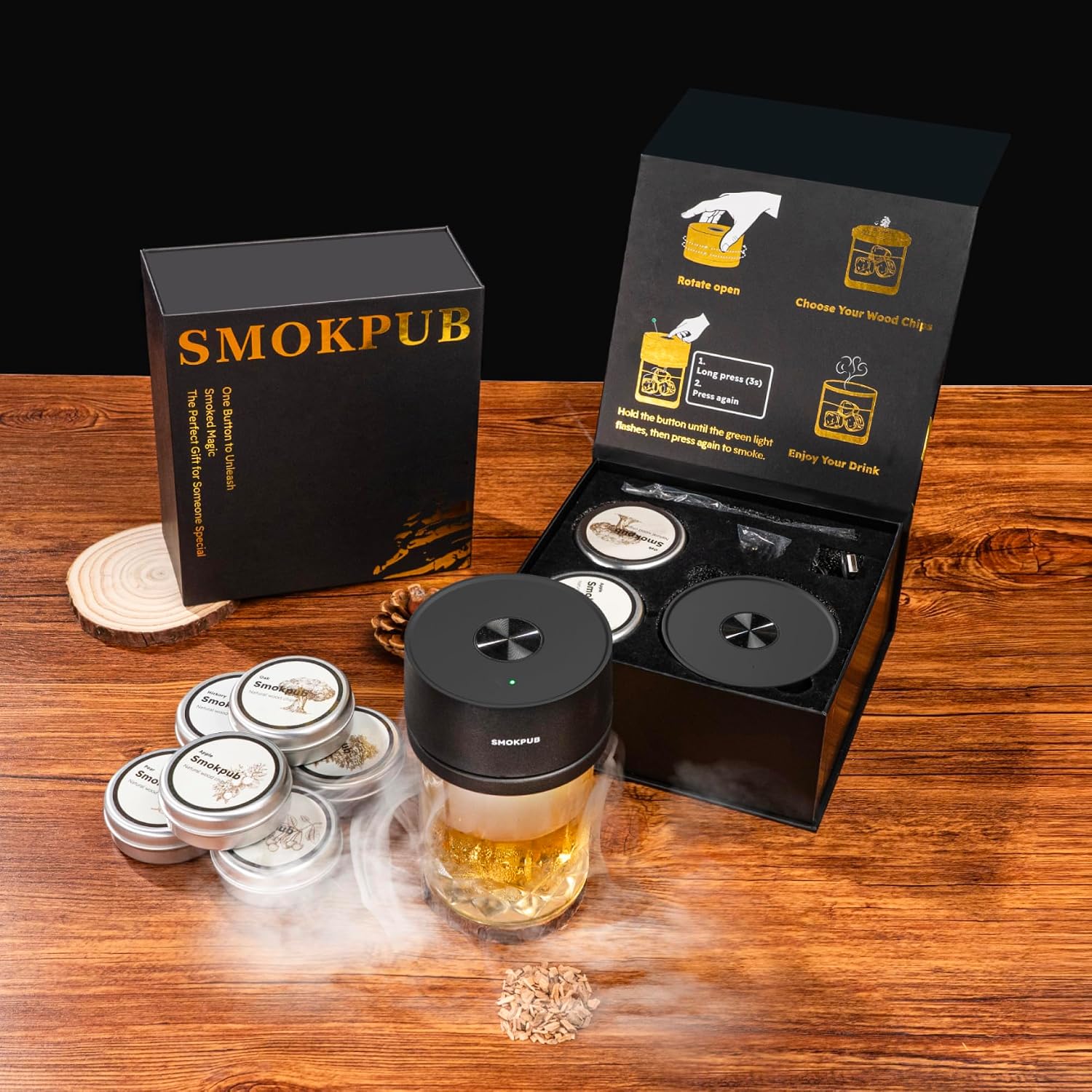 electric cocktail smoker unit and its open gift box on a warm wood table with six tins of wood chips laid out beside it