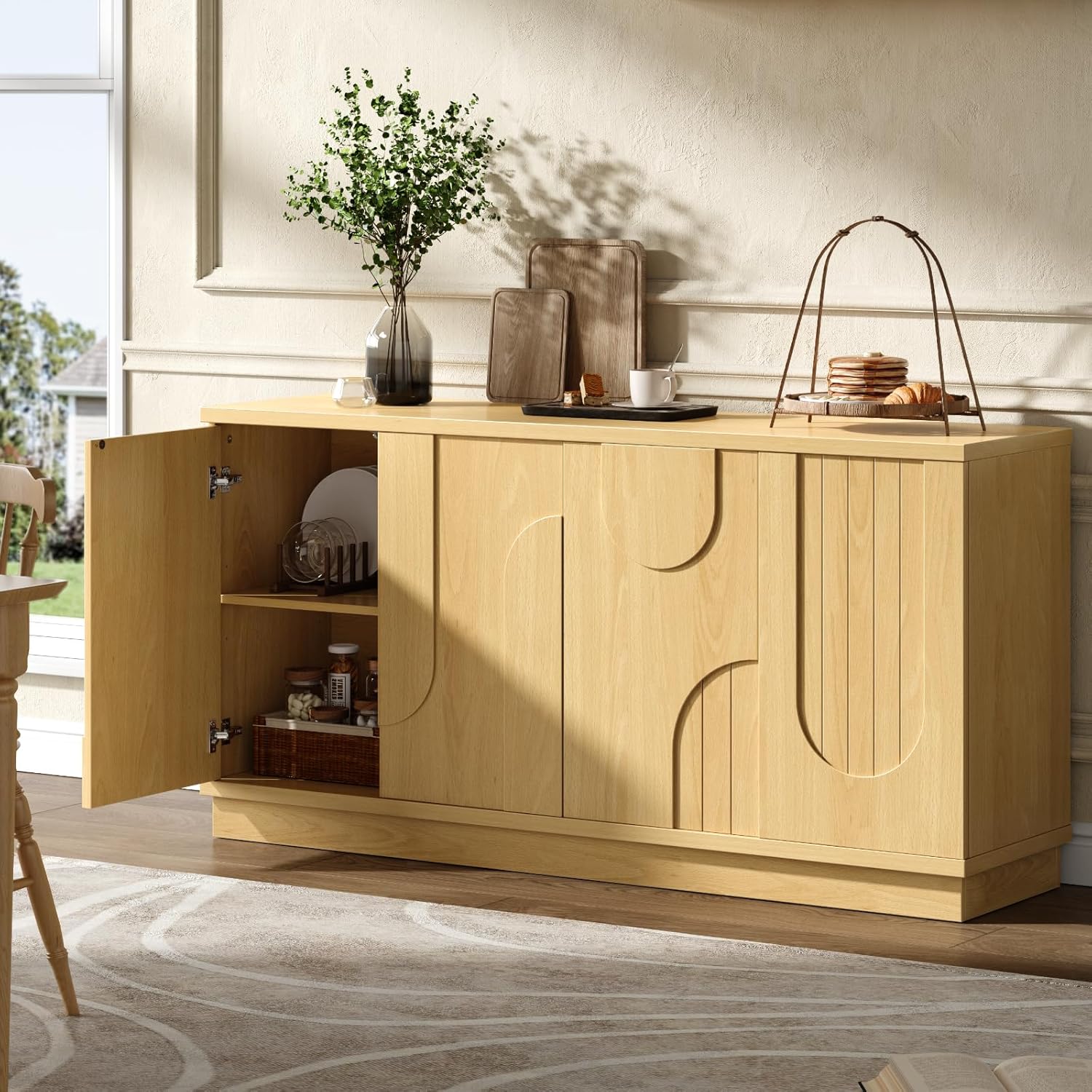 Interior view of the sideboard with adjustable shelves holding various kitchen items.