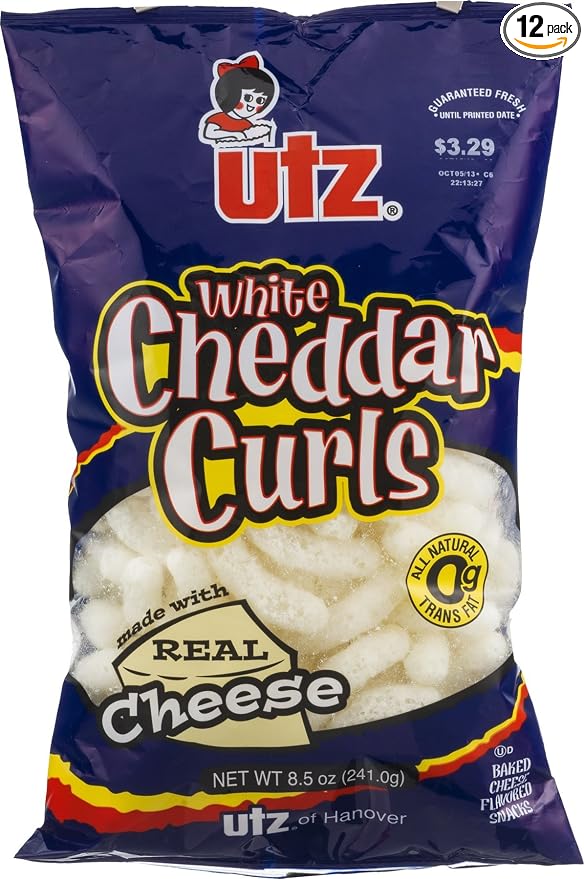 Utz baked Cheese flavored snacks - White cheddar curls corn meal, vegetable Oil (contains One or more of the following: cottons (041780013552)