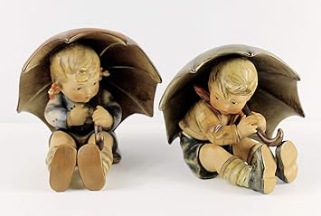 hummel boy walking with umbrella