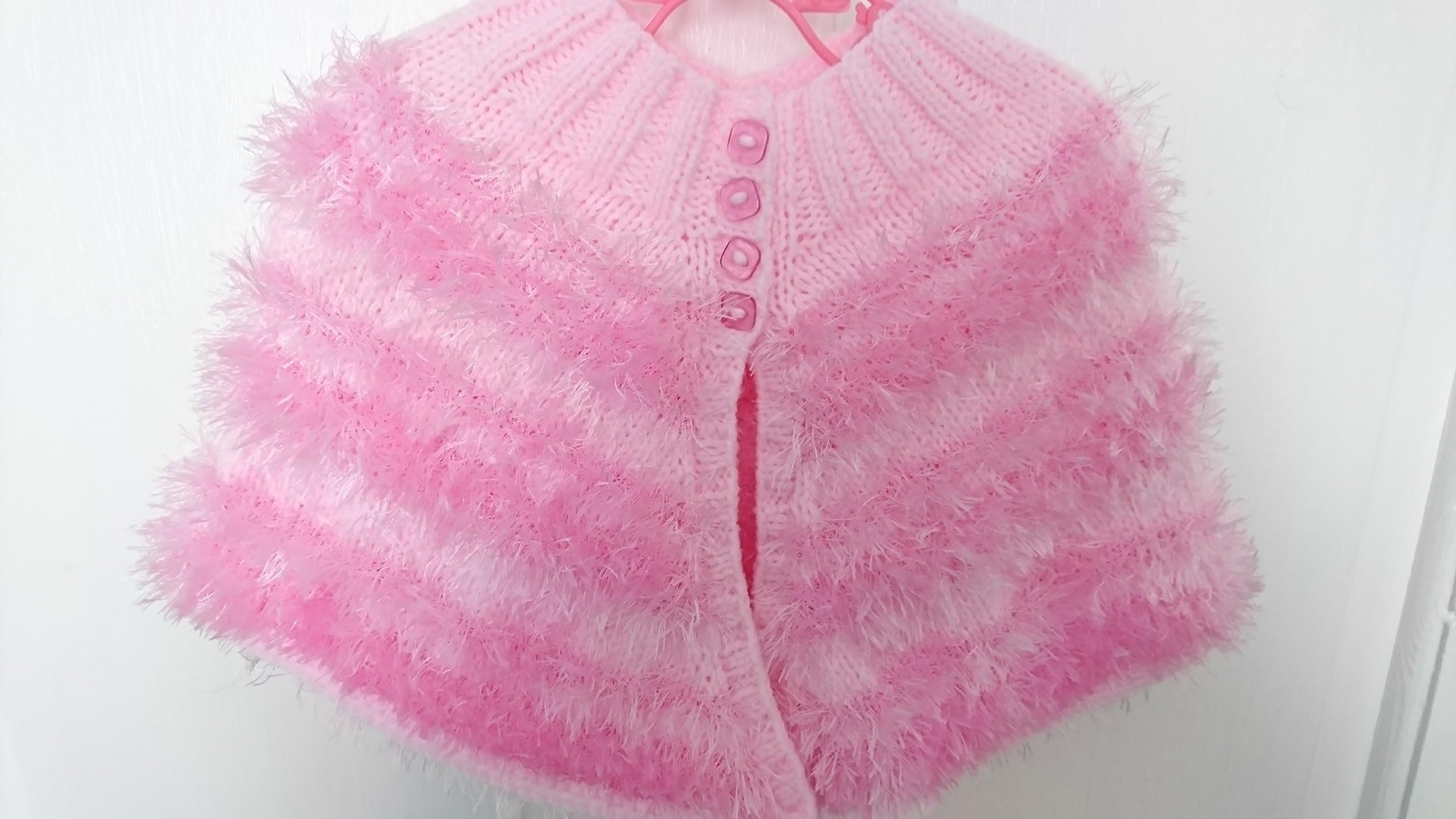 Elsa -Newborn, hand knitted, pink baby girls poncho knitted in stunning eyelash wool.