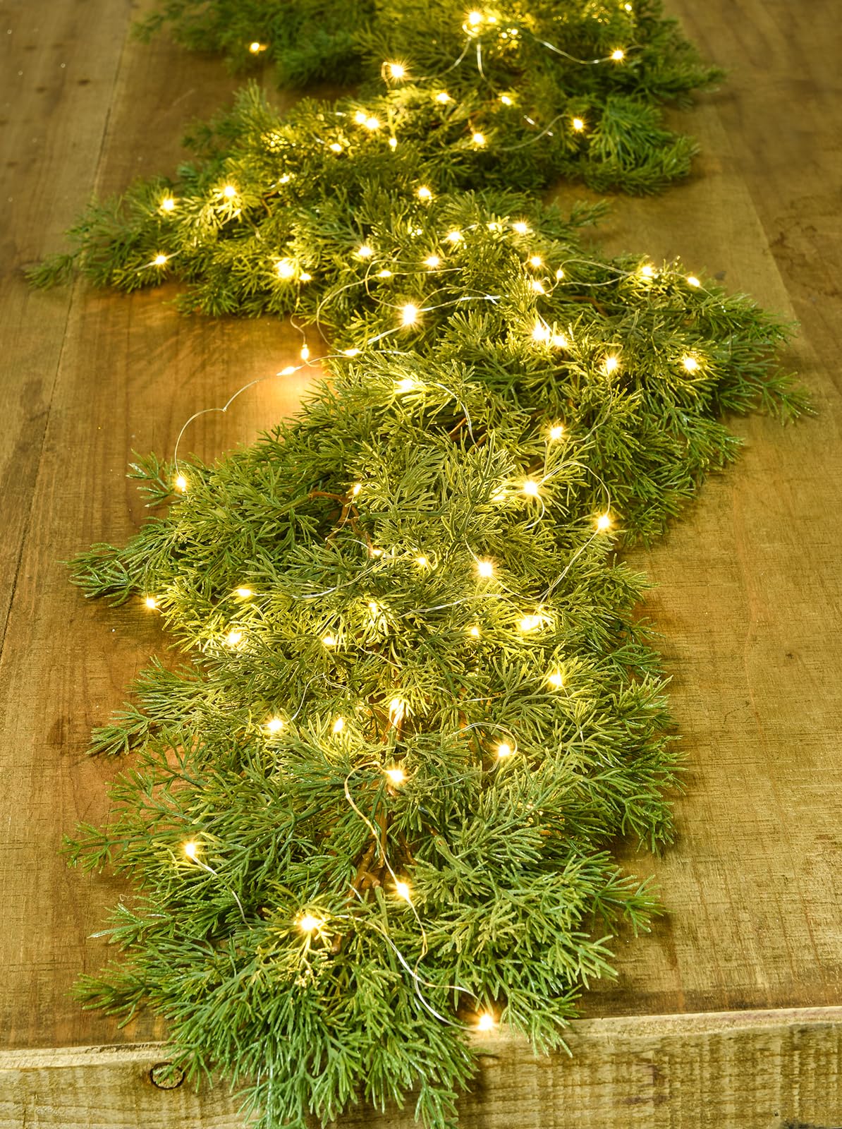 Photo 1 of DearHouse 6Ft Artificial Christmas Pine Garland with 50 LED Lights, Winter Greenery Garland Realistic Cypress for Holiday Season Mantel Fireplace Table Runner Centerpiece Decoration
