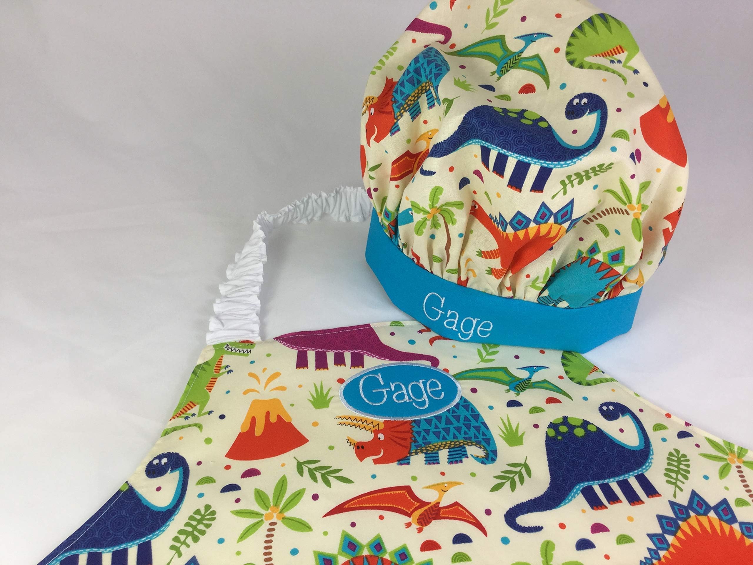 Kids or adult dinosaur aprons with optional personalised embroidery and optional chef hat. Handmade in UK by Babahoot