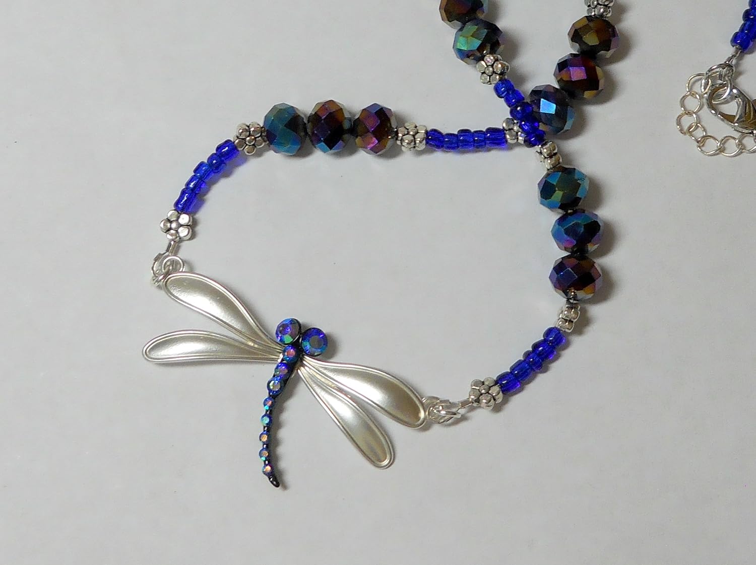 dark blue and silver dragonfly