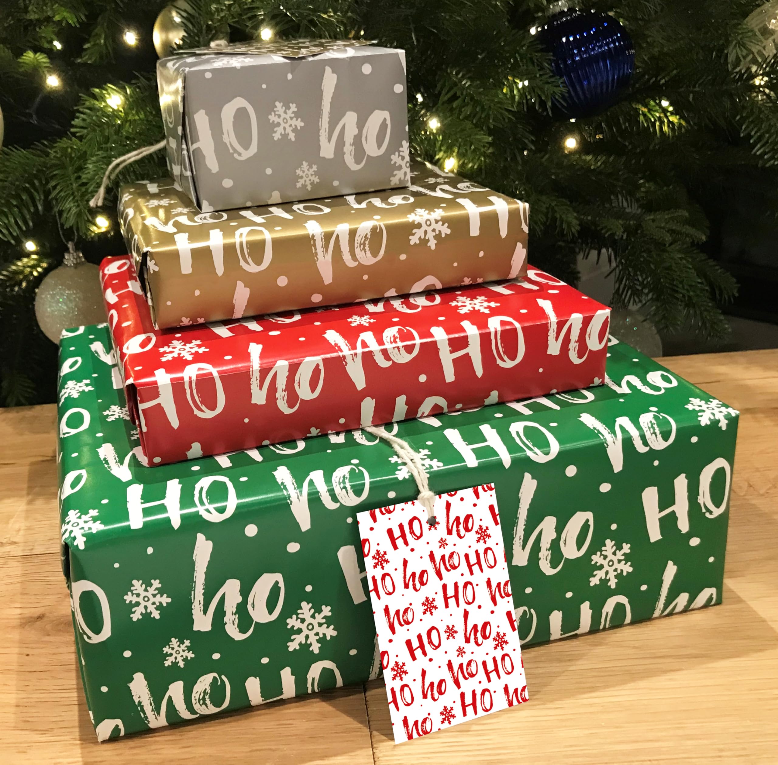Christmas Wrapping Paper. 8 XL Sheets (50 x 70cm). HoHoHo Design in 4 Colours Including Metallic Silver and Gold. Gift Wrap Pack with Matching Tags. Cutting Grid on Reverse.