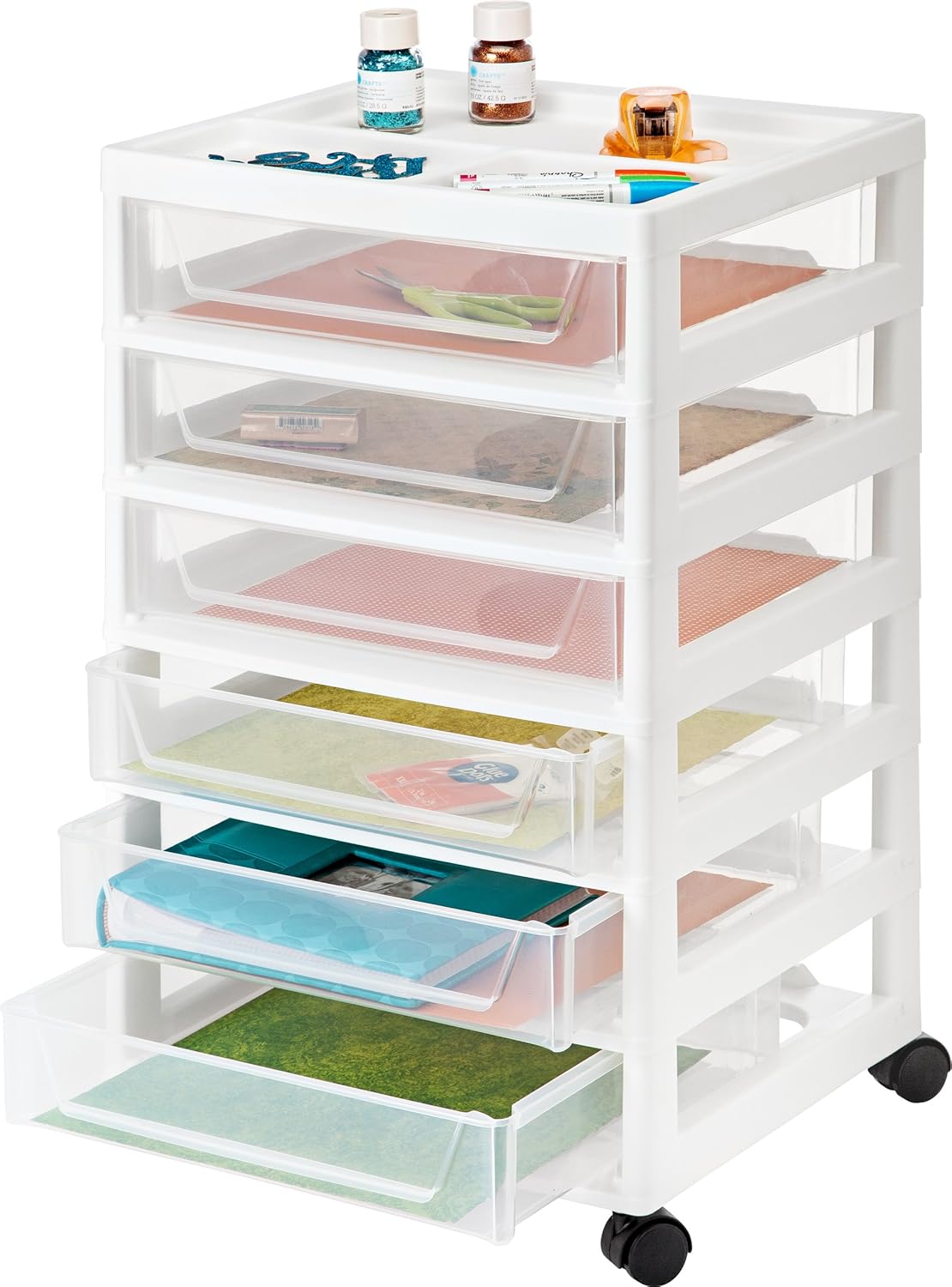 A product image of a six-drawer plastic rolling craft cart paper organizer. Each drawer is full of 12x12 cardstock and a blue scrapbook. The top of the cart is a mini-table that holds other crafting supplies.