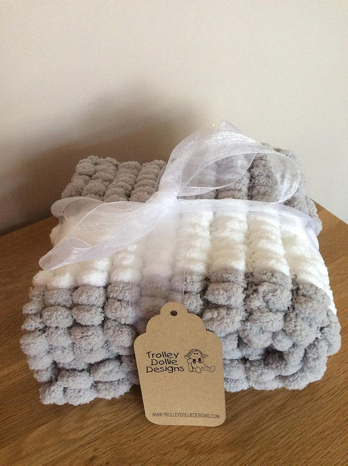 grey pom pom baby blanket