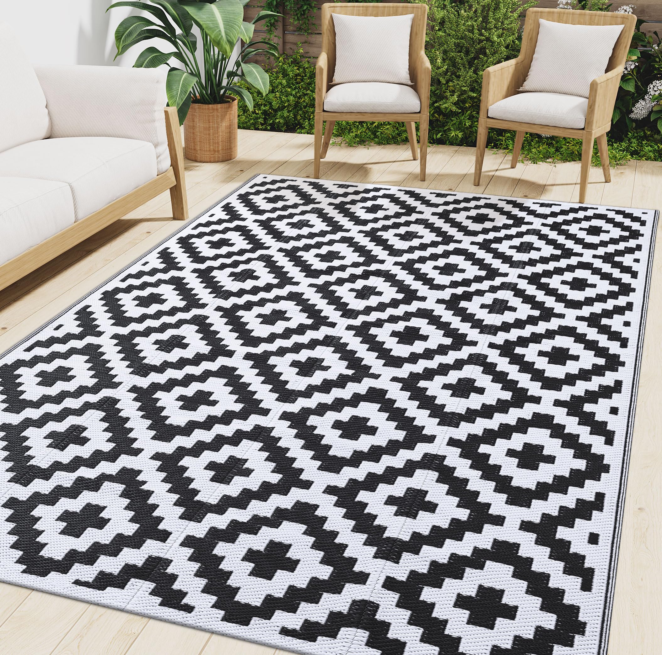 Photo 1 of Smiry Waterproof Outdoor Rug 6x9 ft, Reversible Plastic Straw Patio Camping Rugs, Outdoor Indoor RV Mat Carpet for Patio, Outside Entry, Backyard, Deck, Bench, Picnic, Camper, Black & White