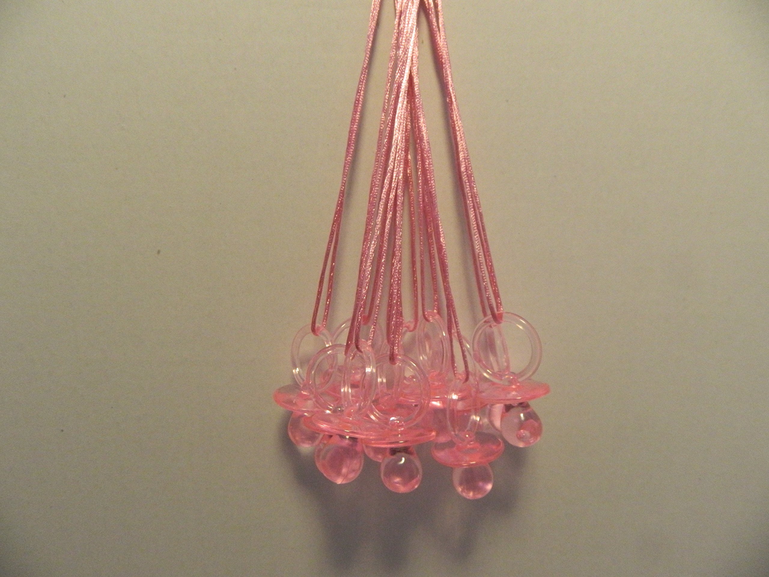 pink plastic pacifiers for baby shower