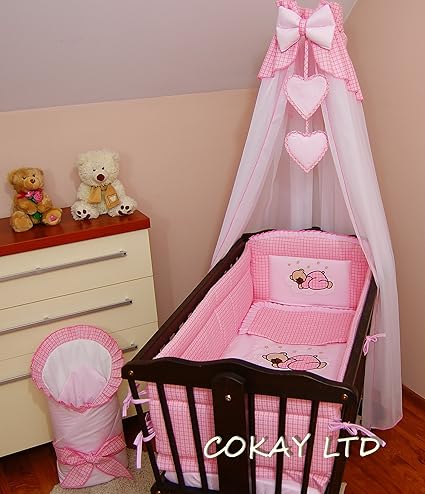 white swinging crib with drapes