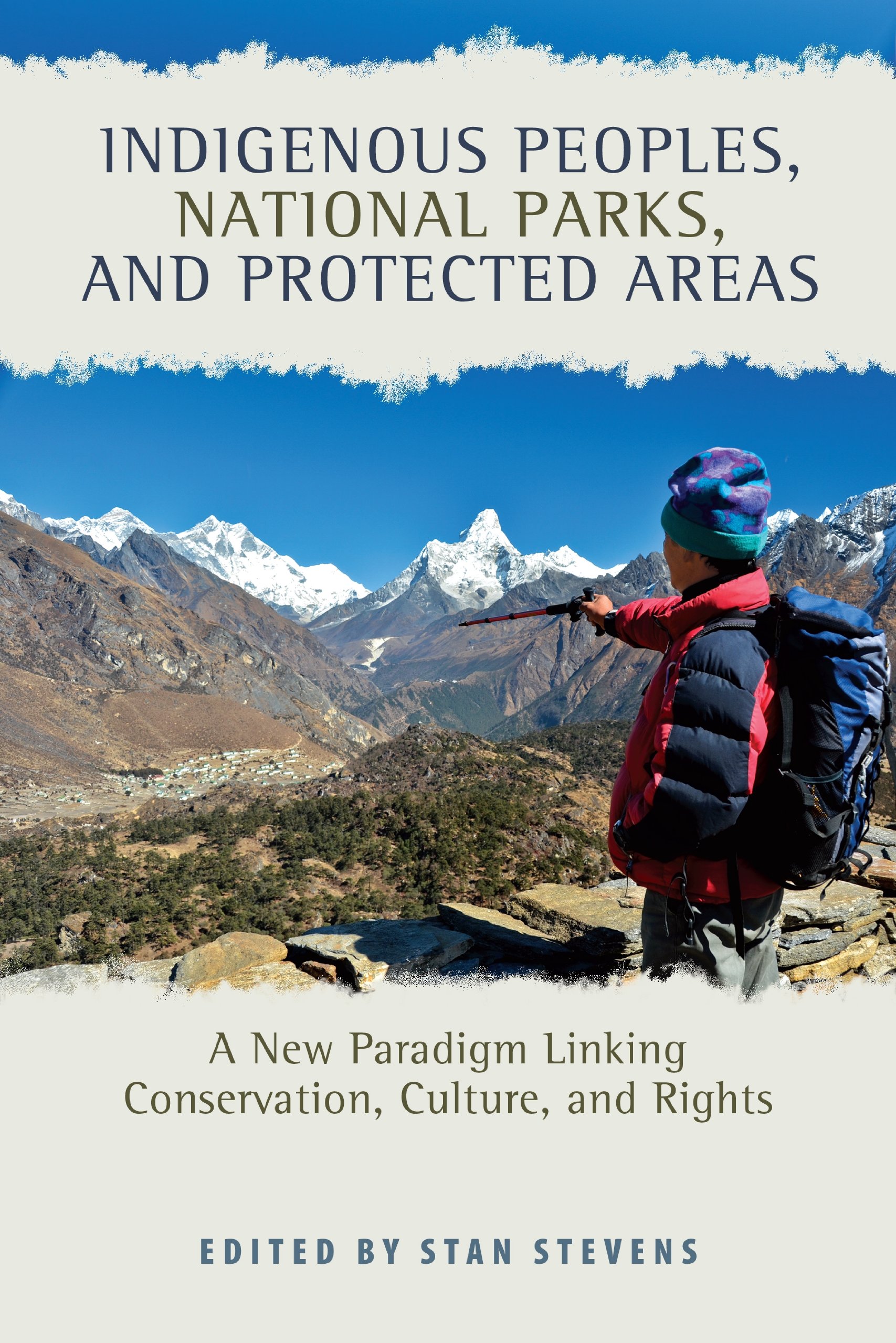 The cover of Indigenous Peoples, National Parks, and Protected Areas: A New Paradigm Linking Conservation, Culture, and Rights. There is an image of a hiker on a mountain pointing towards other mountains in the distance.
