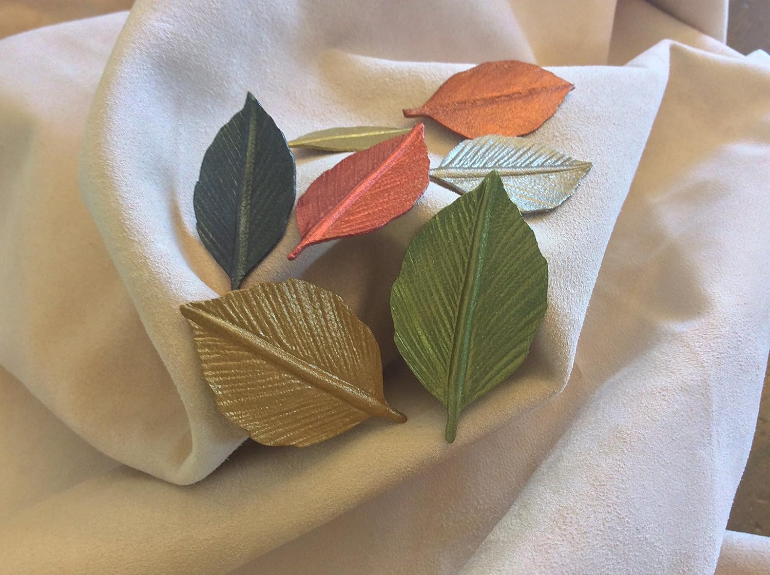 Leather leaves with a stem. 1.25" metallic leaves (craft