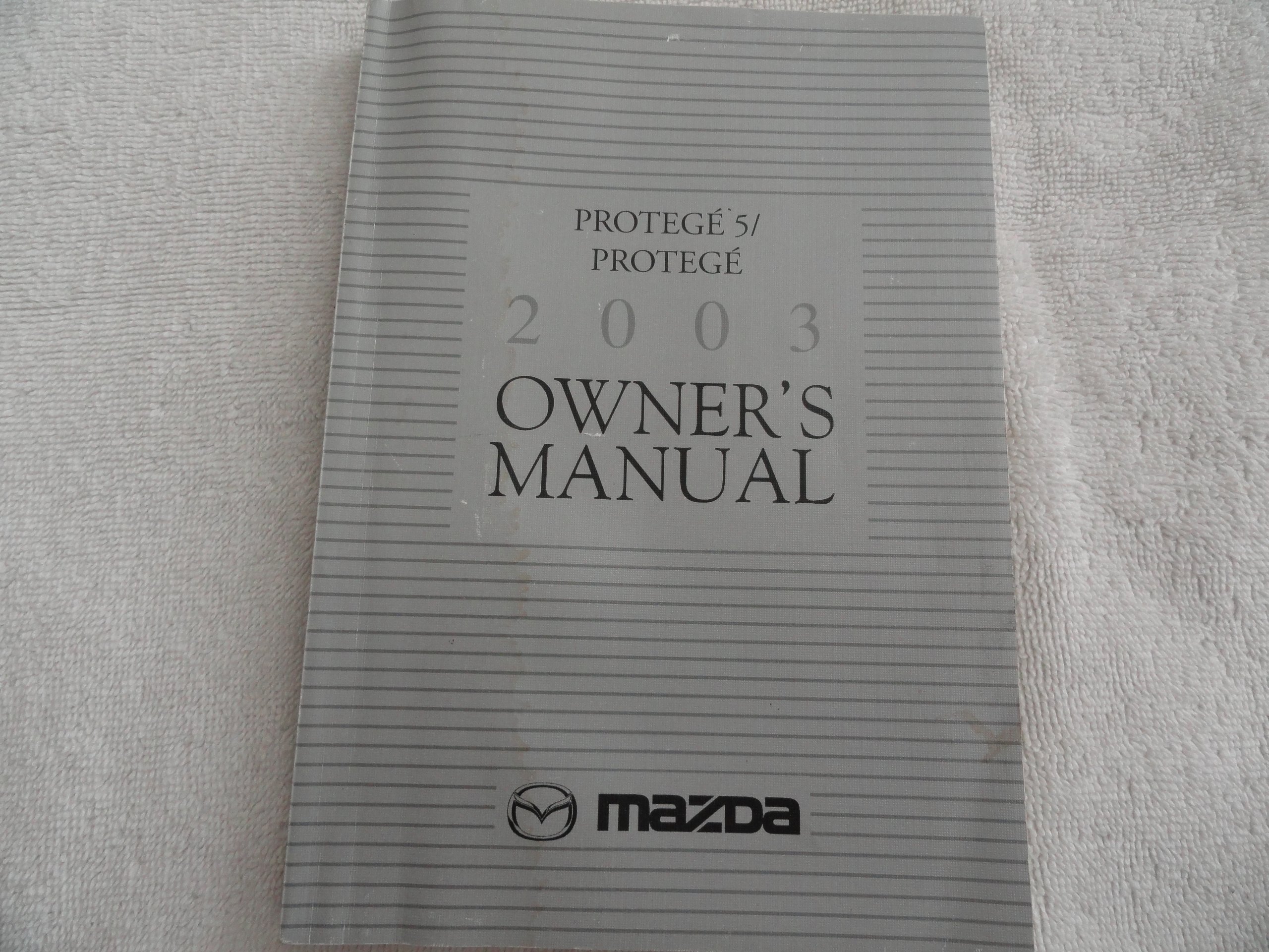 2003 Mazda Protege Owners Manual Paperback – 2003