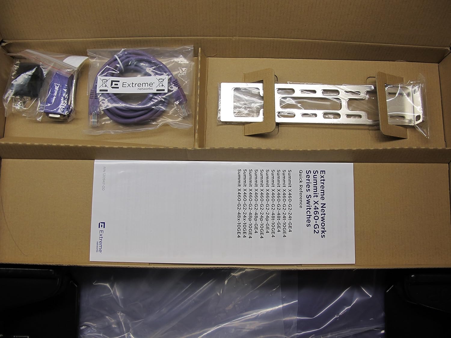 Contents of the Extreme Networks Summit X460-G2-48T-10GE4 switch box, including the switch, cables, rackmount ears, and documentation.