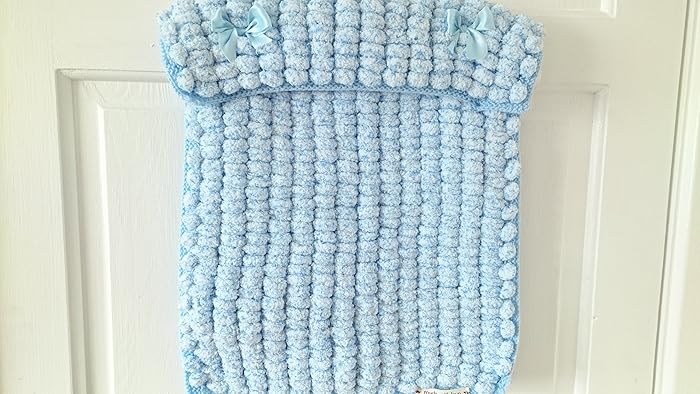 white pom pom baby blanket