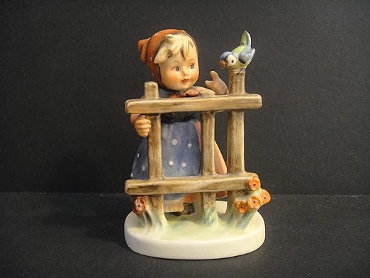 hummel boy on fence with bird