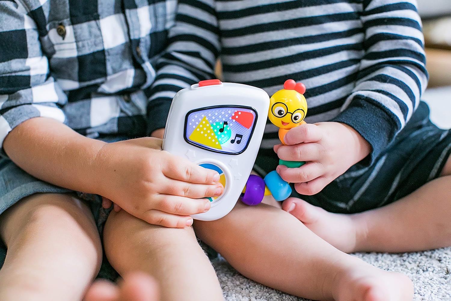 children holding Baby Einstein Take Along Tunes Musical Toy