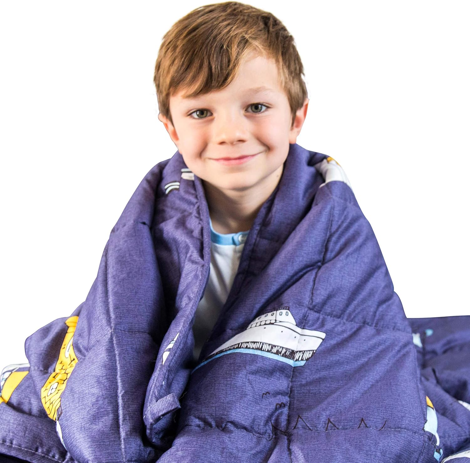 A boy snuggled in a LUNA Kids weighted blanket.