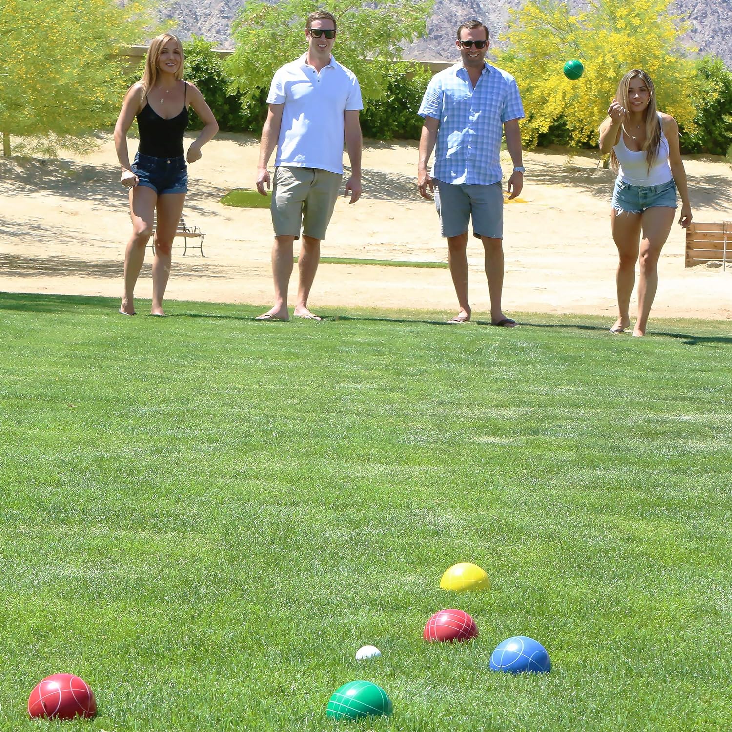 People playing bocce ball in the backyard
