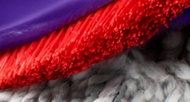 Abstract composition showing layers of purple, red, and white textured materials or surfaces meeting at diagonal angles.
