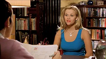 Reese Witherspoon as Elle Woods, taking with her career advisor in the Legally Blonde game.