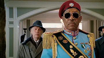 Bruce Willis holding a gun with Helen Mirren, Morgan Freeman, and John Malkovich behind him in the RED game