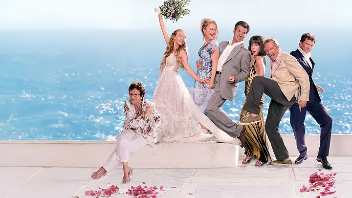 Donna Sheridan (Meryl Streep), Sophie Sheridan (Amanda Seyfried), Sam Carmichael (Pierce Brosnan), Harry Bright (Colin Firth), Bill Anderson (Stellan Skarsgård), Rosie Mulligan (Julie Walters), Sky Rymand (Dominic Cooper), and Tanya Chesham-Leigh (Christine Baranski) pose with each other on a Greek Island on the poster for the Mamma Mia! game