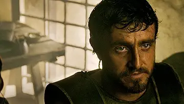 Paul Mescal as Lucius standing in the Colosseum arena with gladiators behind him in the Ridley Scott Gladiator II game.