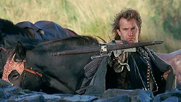 Kevin Costner about to release a flaming arrow in Robin Hood: Prince of Thieves (1991).