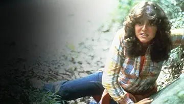 Annie (Robbi Morgan) flees from Pamela Voorhees (Betsy Palmer) in the Friday the 13th game.