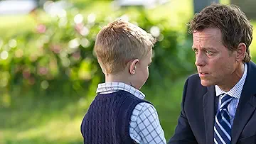 Greg Kinnear (Tudd Burpo) holds Connor Corum's (Colton Burpo) hand on the poster for Heaven Is for Real (2014) for the Heaven Is for Real game.