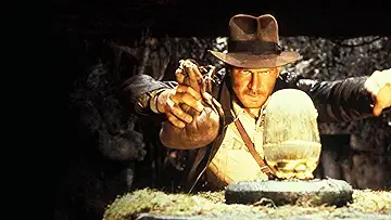 Indiana Jones gazes at a golden idol in Steven Spielberg's Raiders of the Lost Ark (1981).