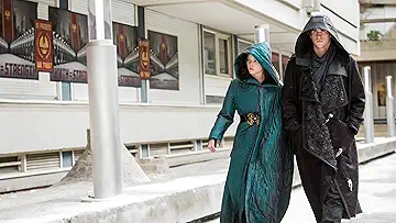 Jennifer Lawrence as Katniss Everdeen in full Mockingjay armor holding her bow in The Hunger Games: Mockingjay Part 2 game.