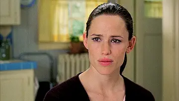 Jennifer Garner smiling in a colorful dress in the poster for 13 Going on 30, the 13 Going on 30 game.