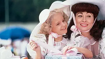 A silhouette of Joan Crawford's (Faye Dunaway) iconic face on the poster for Mommi Dearest (1981) for the Mommie Dearest game.