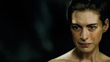 Hugh Jackman as Jean Valjean standing on a ship with a flag in the Tom Hooper Les Miserables game