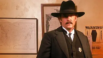 Kevin Costner as Wyatt Earp, firing a gun on the poster for the Wyatt Earp game