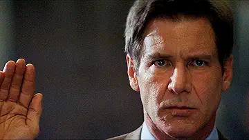 Harrison Ford as Jack Ryan with a serious expression in a scene from Clear and Present Danger (1994).