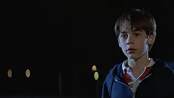 Barrett Oliver (Daryl) poses with a baseball bat and a space helmet on the poster for the D.A.R.Y.L. game