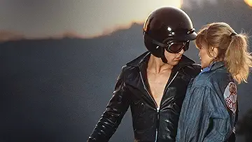 Stephanie Zinone (Michelle Pfeiffer) and Michael Carrington (Maxwell Caulfield) get close and personal on the poster for the Grease 2 game