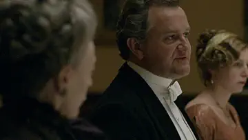 Robert Crawley (Hugh Bonneville) talks over dinner in the Downton Abbey Season 1 Episode 6 game