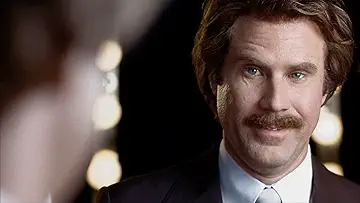 Will Ferrell as Ron Burgundy with the Channel 4 Evening News team (Steve Carell as Brick Tamland, Paul Rudd as Brian Fantana, Christina Applegate as Veronica Corningstone, and David Koechner as Champ Kind) in the poster for Anchorman (2004).