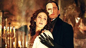 Gerard Butler as the Phantom embraces Emmy Rossum's Christine Daaë in Andrew Lloyd Webber's The Phantom of the Opera (2004). Play The Phantom of the Opera game.